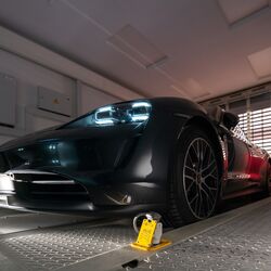 The car is parked in a parking bay on a parking platform