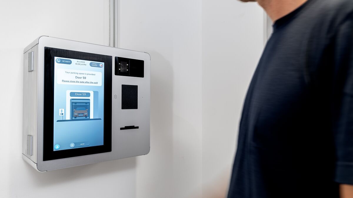 Une personne utilise le terminal de commande du WÖHR Combilift 542/543 pour gérer le processus de stationnement.