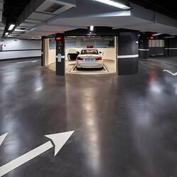The car is parked in an entry bay on a parking platform